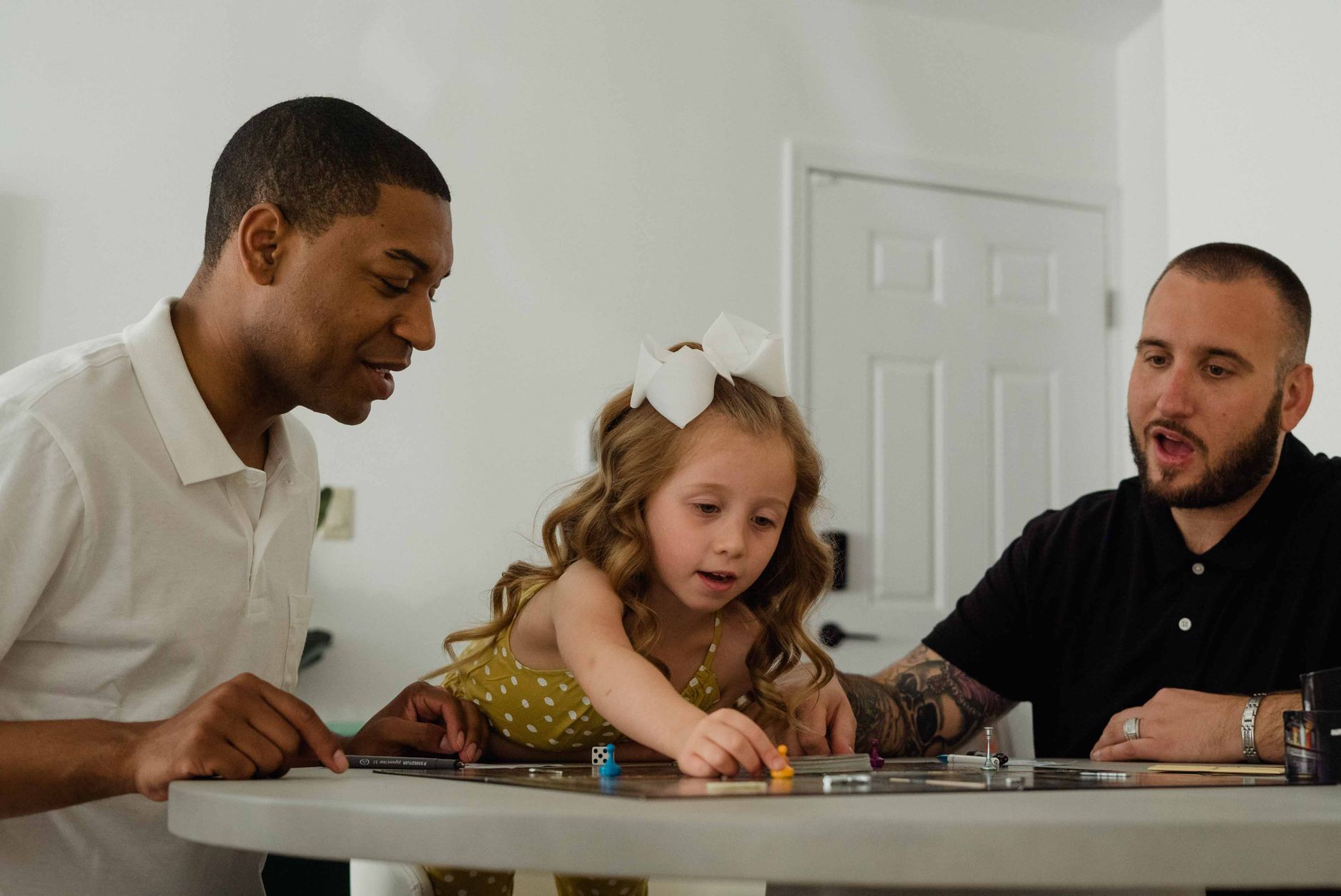 A diverse group enjoying a fun board game session indoors, fostering family connections.