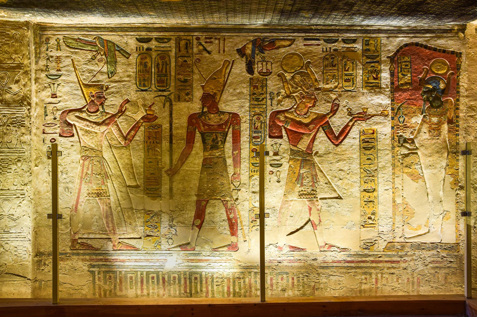 Intricate ancient Egyptian wall reliefs with hieroglyphs and figures.