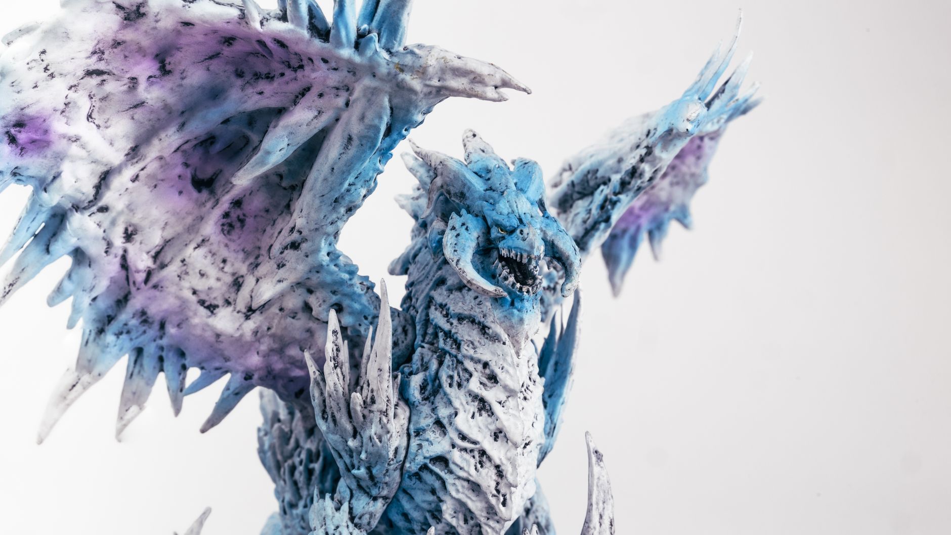 Detailed close-up of a blue dragon figurine with artistic flair, showcasing fantasy themes.