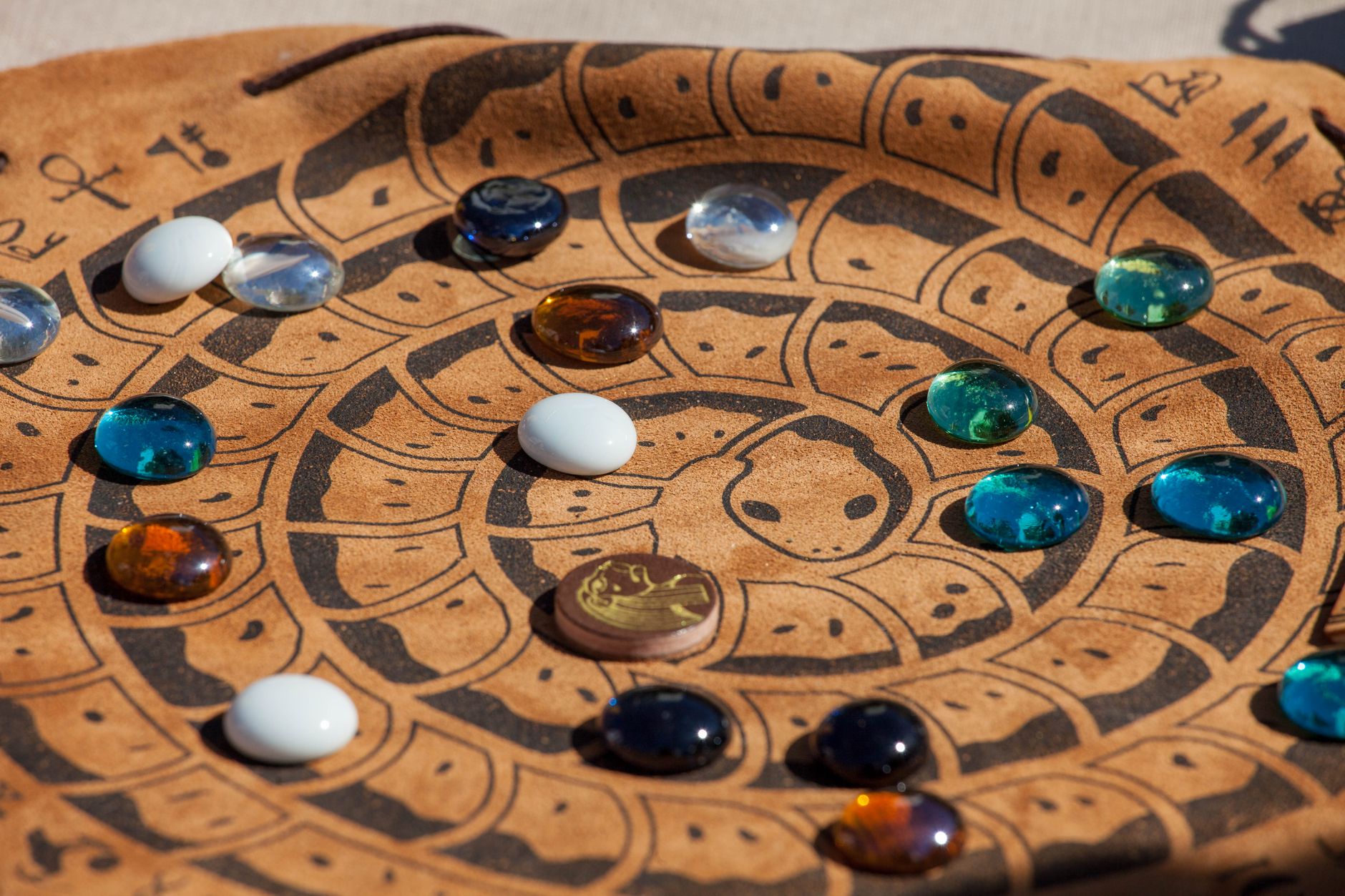 Close-up of a decorative board with colorful glass stones arranged on it.