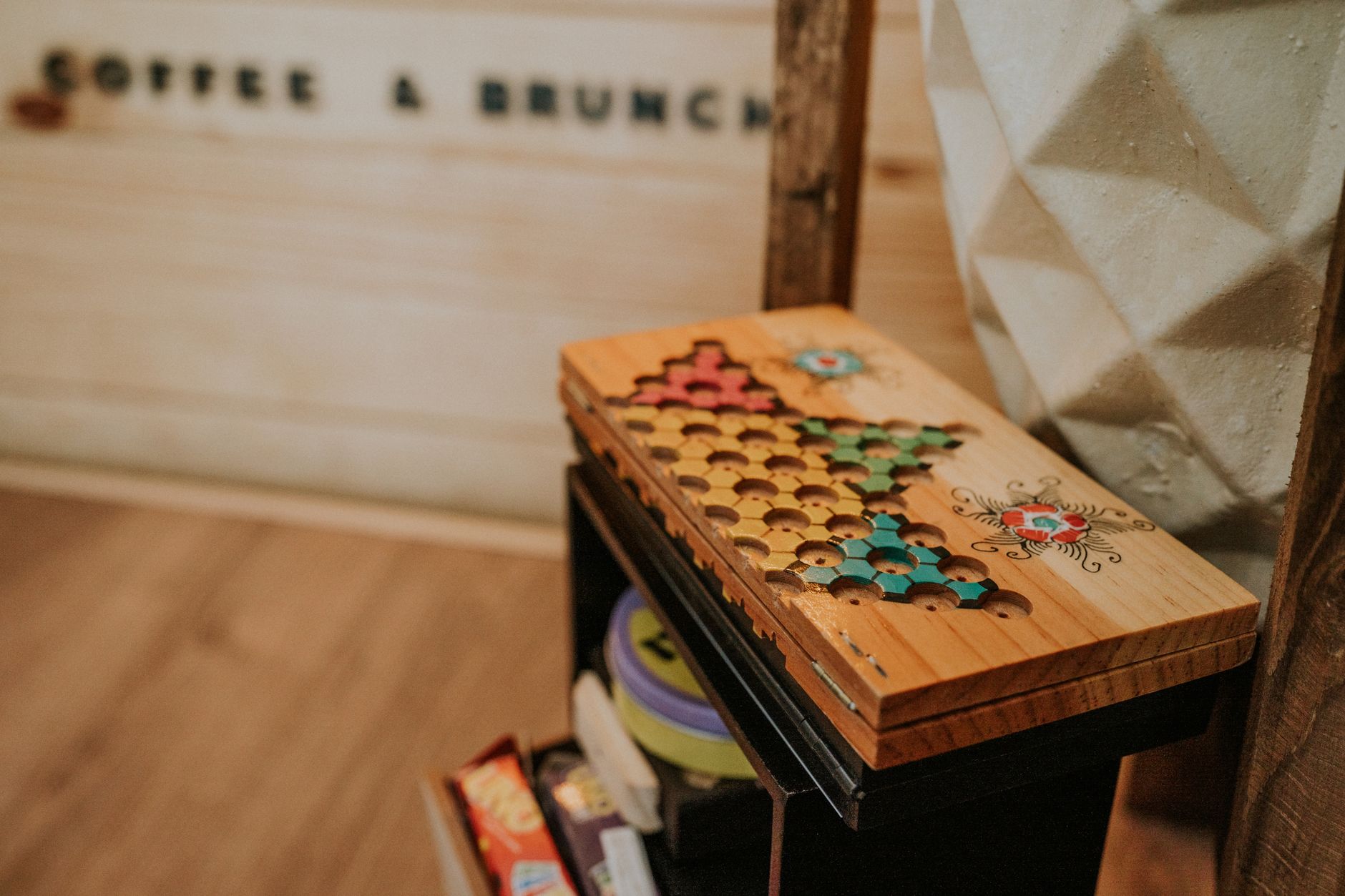 A nostalgic wooden board game set in a cozy cafe setting, evoking retro vibes.