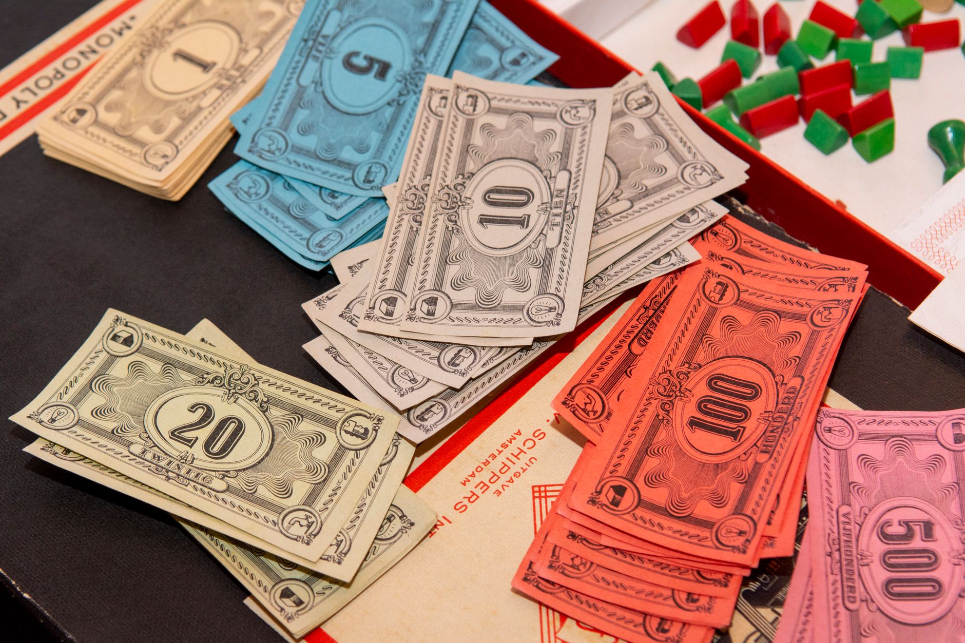 Colorful Monopoly money and game pieces arranged on a game board for a classic board game night.
