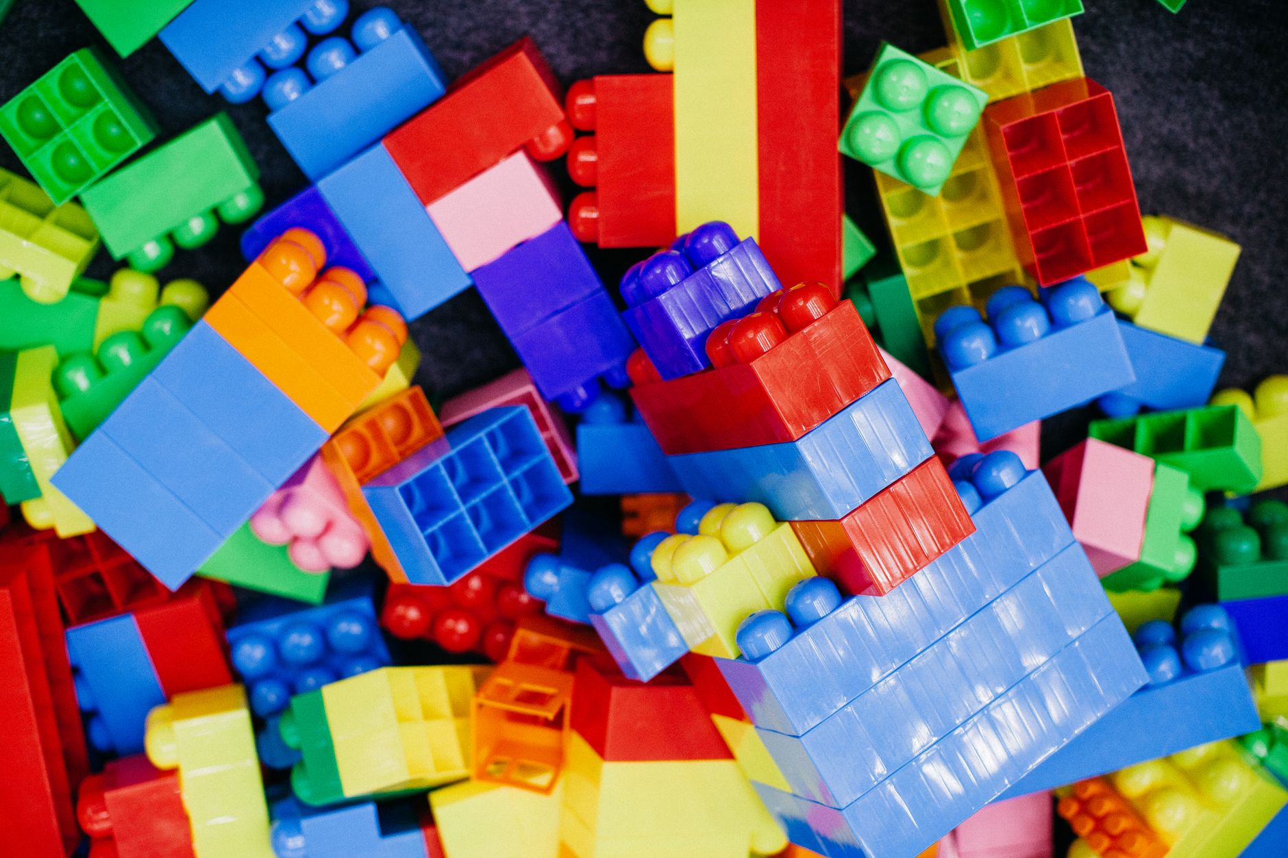 Brightly colored plastic building blocks arranged in a playful pattern, perfect for children's activities.