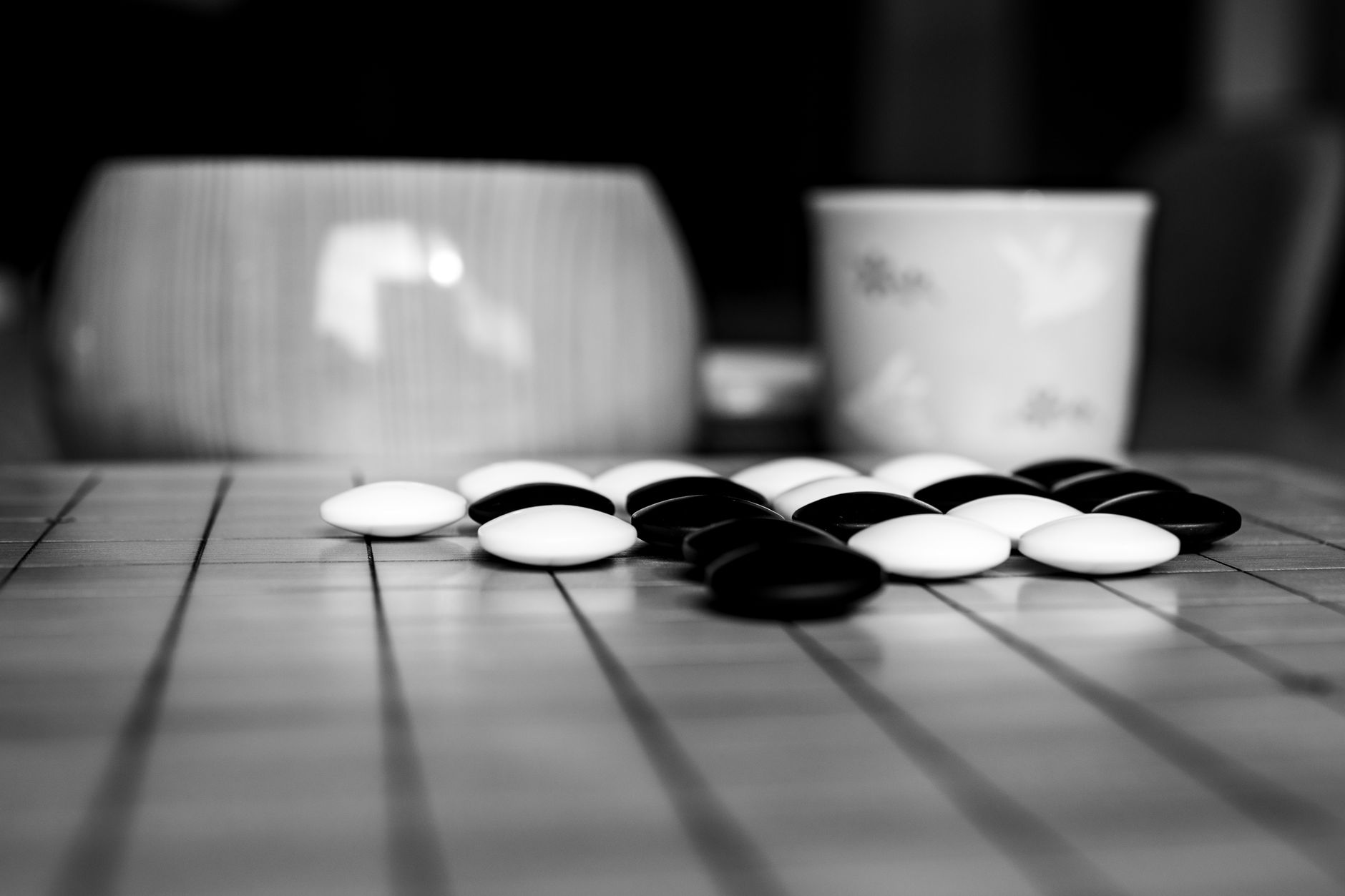 Artistic capture of a Go board with black and white stones, highlighting strategy and contrast.
