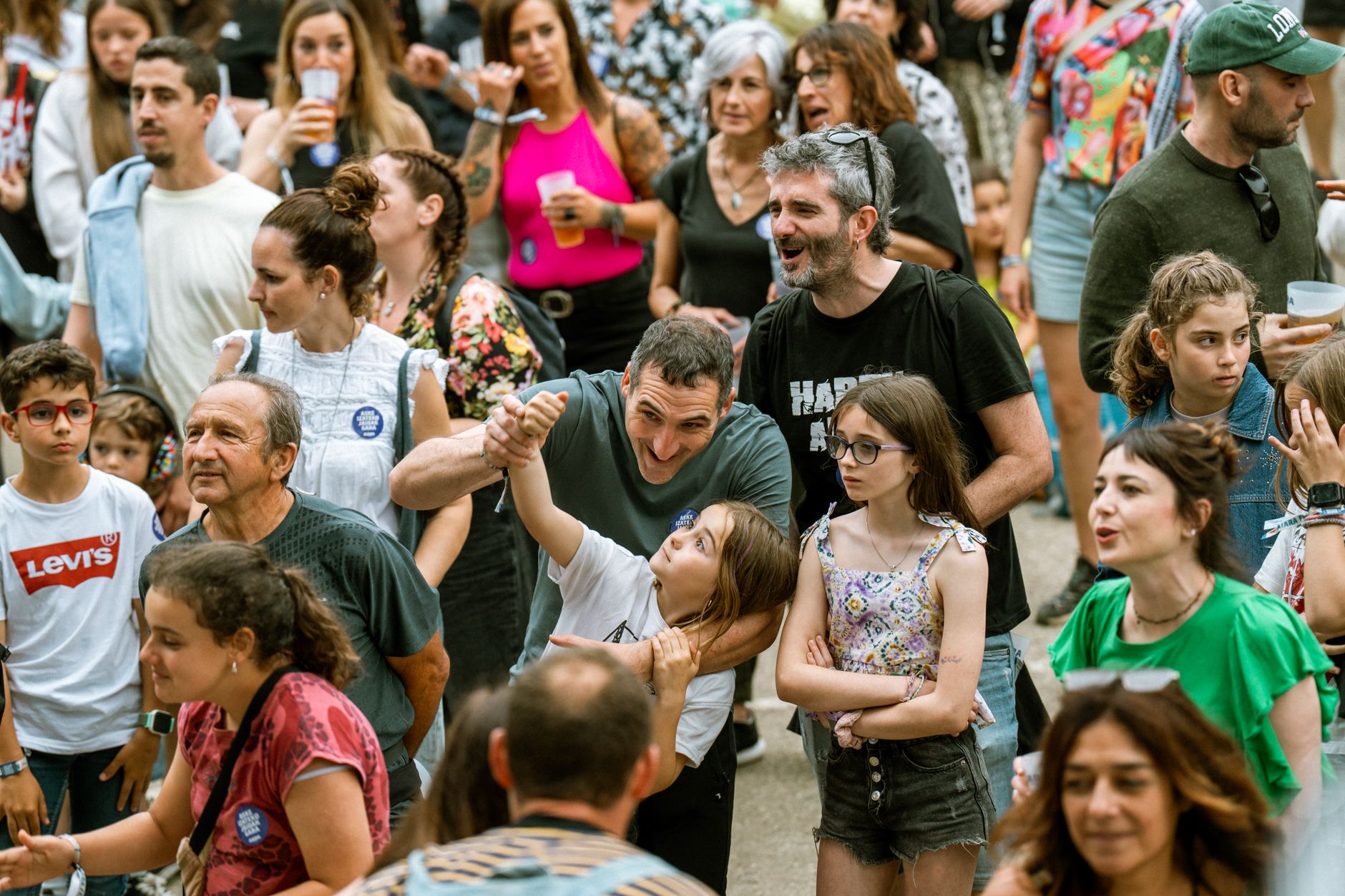 Diverse group of people enjoying a vibrant outdoor festival, capturing joy and community spirit.