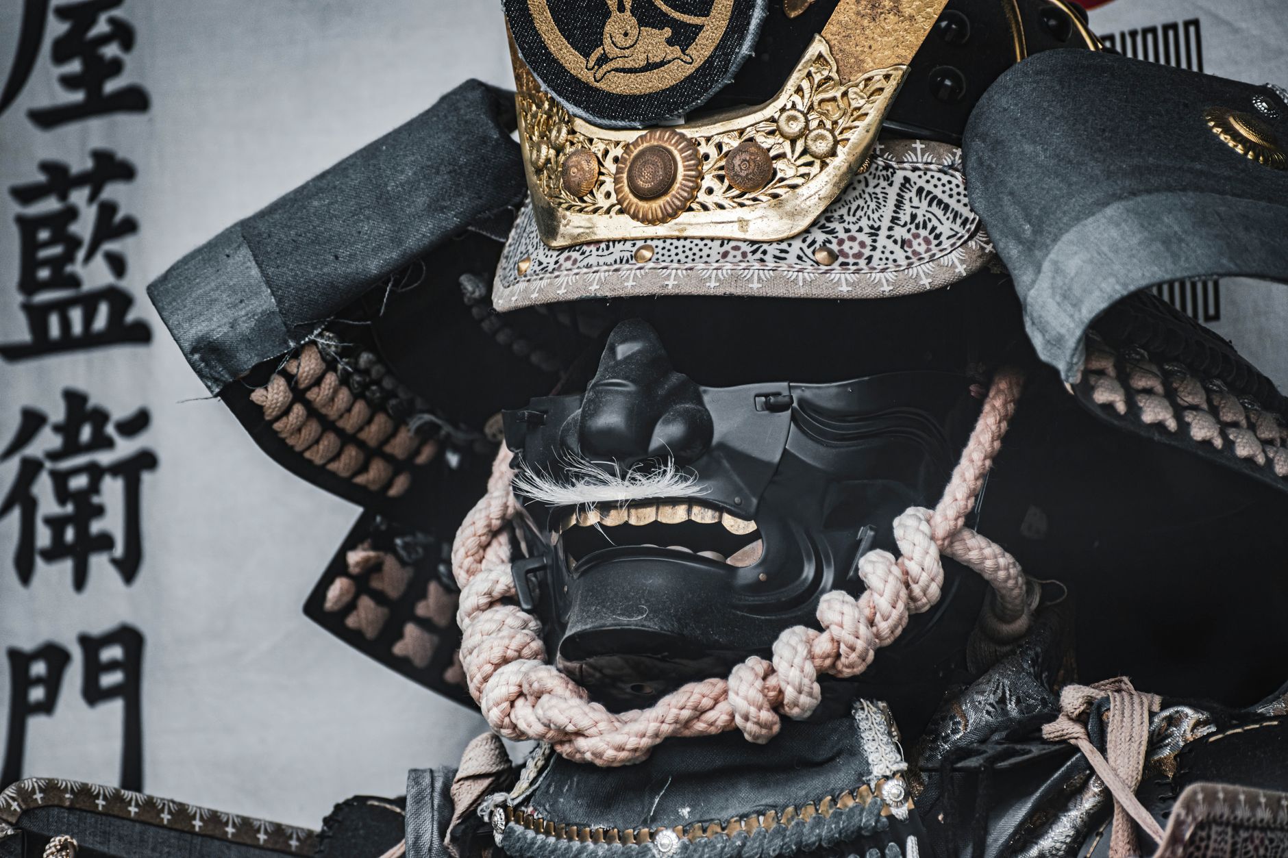 Close-up of a traditional samurai armor and helmet, highlighting intricate craftsmanship and design.