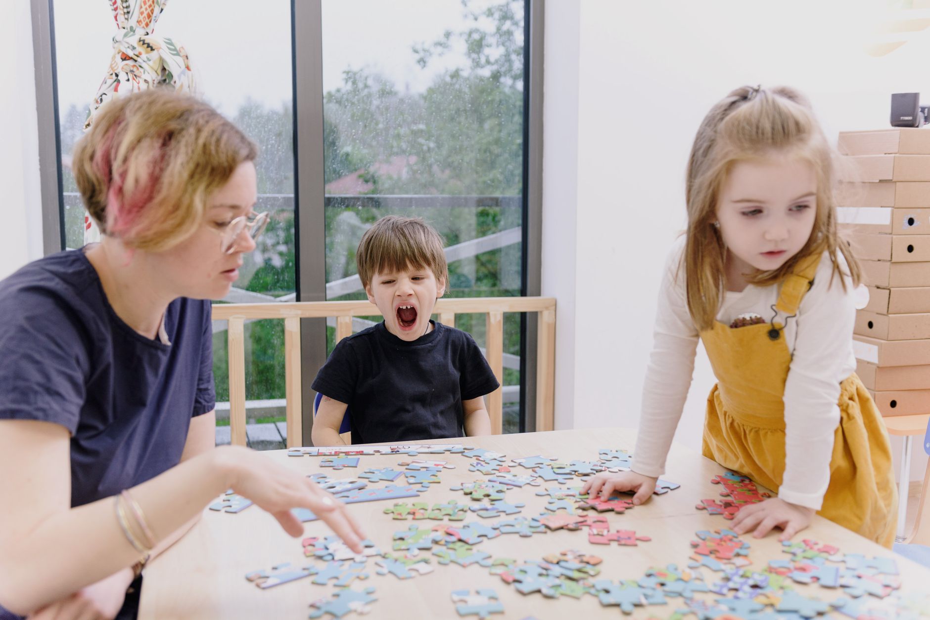 Family engaging in puzzle activity indoors, highlighting creativity and togetherness.