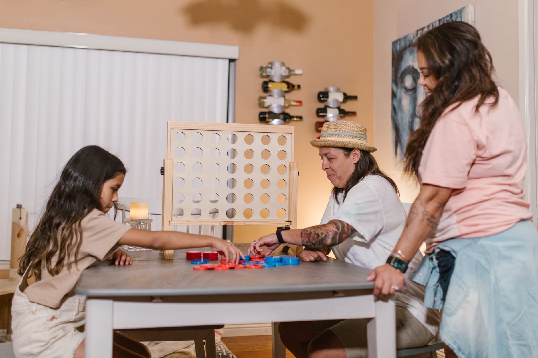 A diverse family enjoys playing a board game at home, fostering connection and fun.